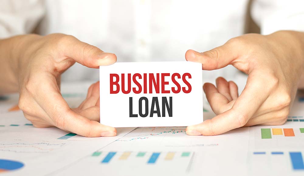 Business loan sign held in hands