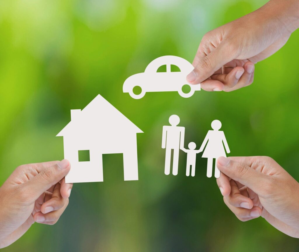 Paper cut-out of a family, house and car