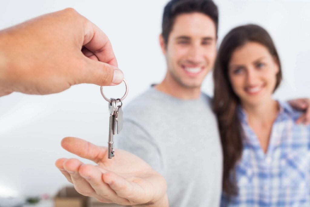 Couple receiving keys to their new home