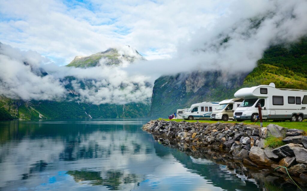Caravans parked beside a mountain lake
