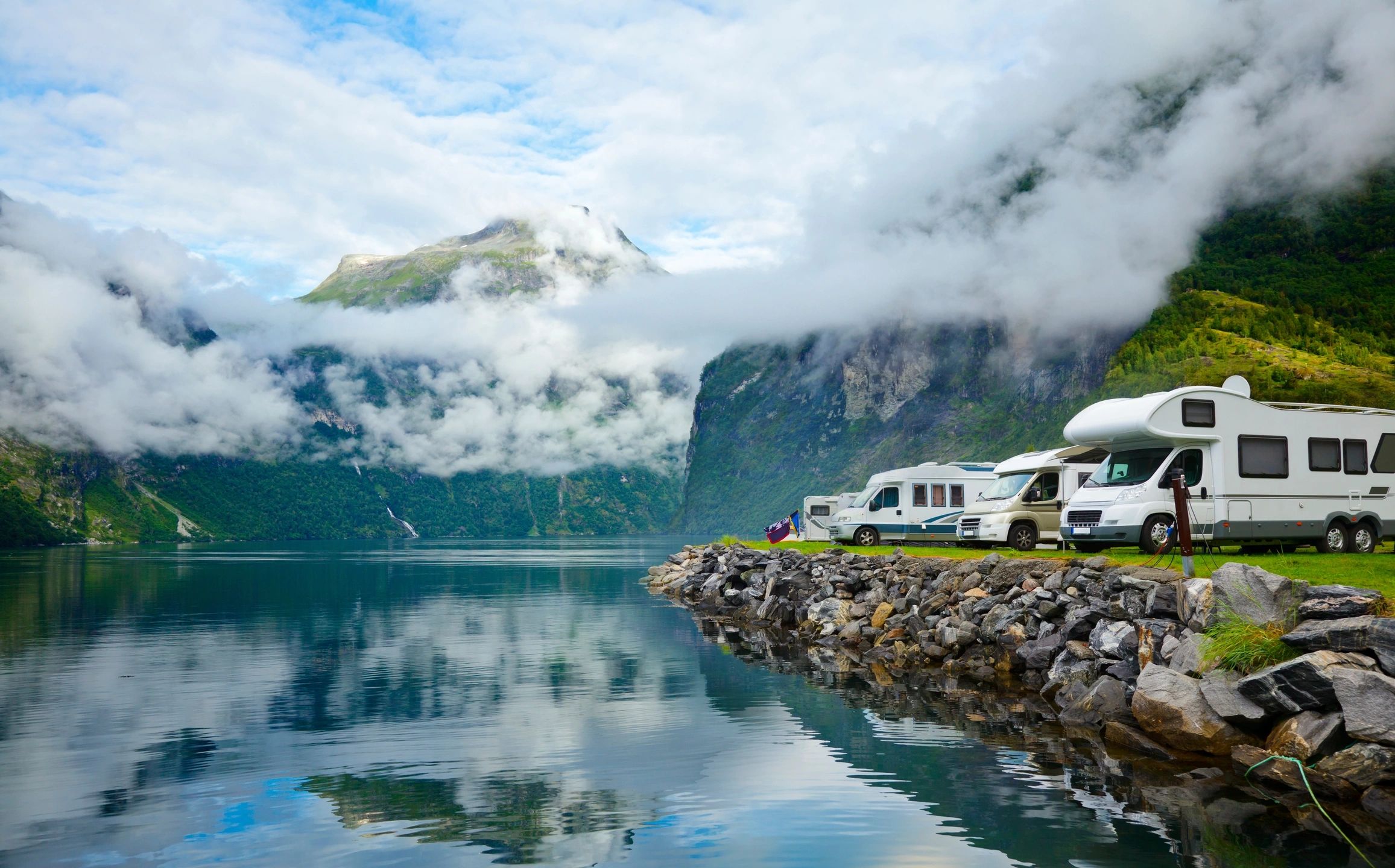 Caravans parked beside a mountain lake