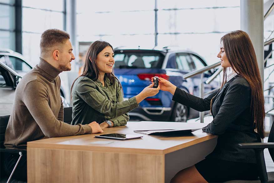 Customer receiving car keys at a dealership